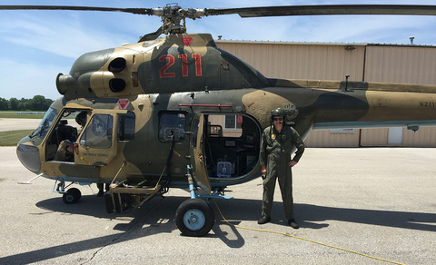 Enrique Leira stands next to helicopter